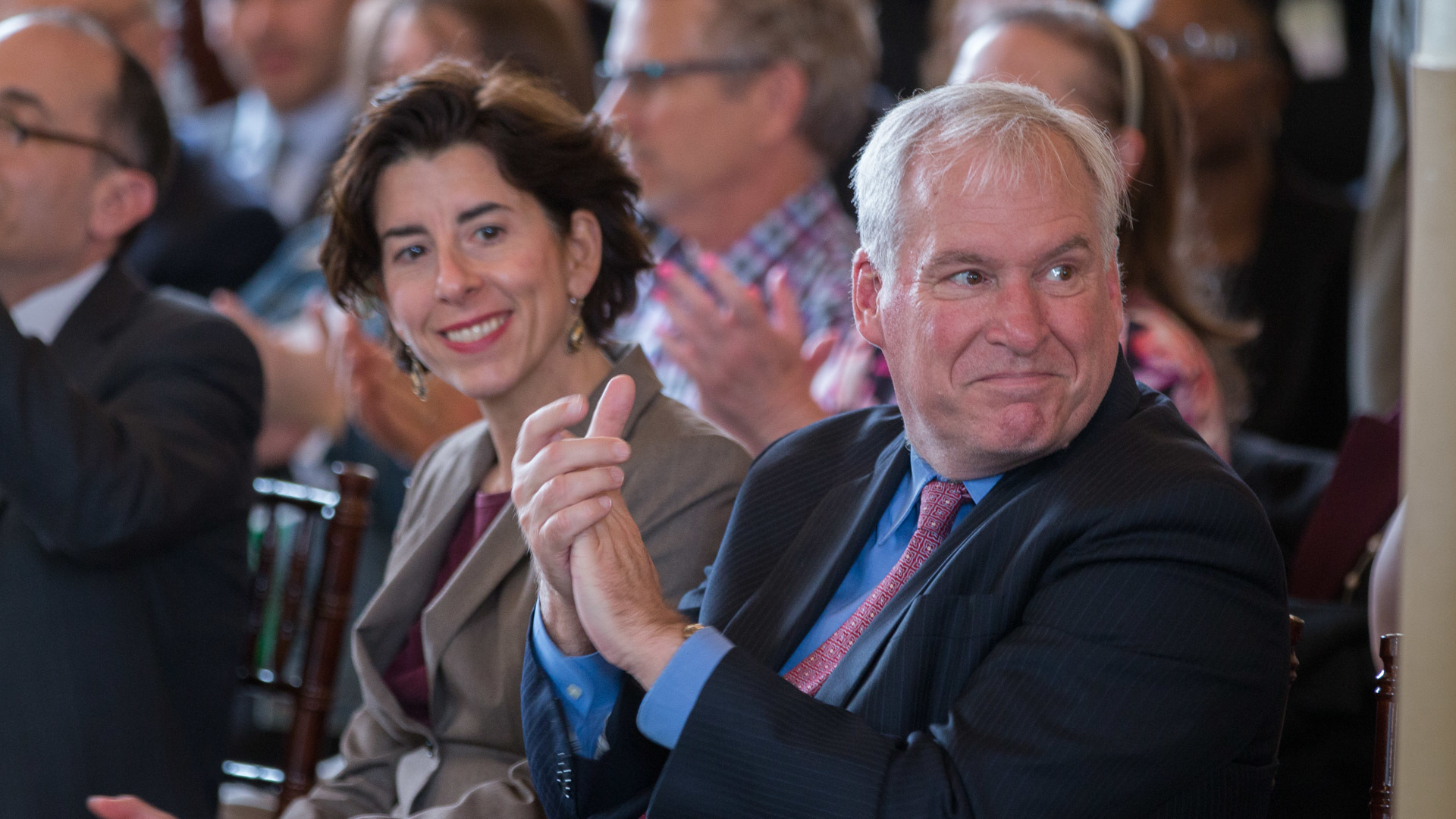 Photo of Eric S. Rosengren and Rhode Island Governor, Gina Raimondo clapping for the cities that won a multiyear grants in Rhode Island for the Working Cities Challenge Competition.
