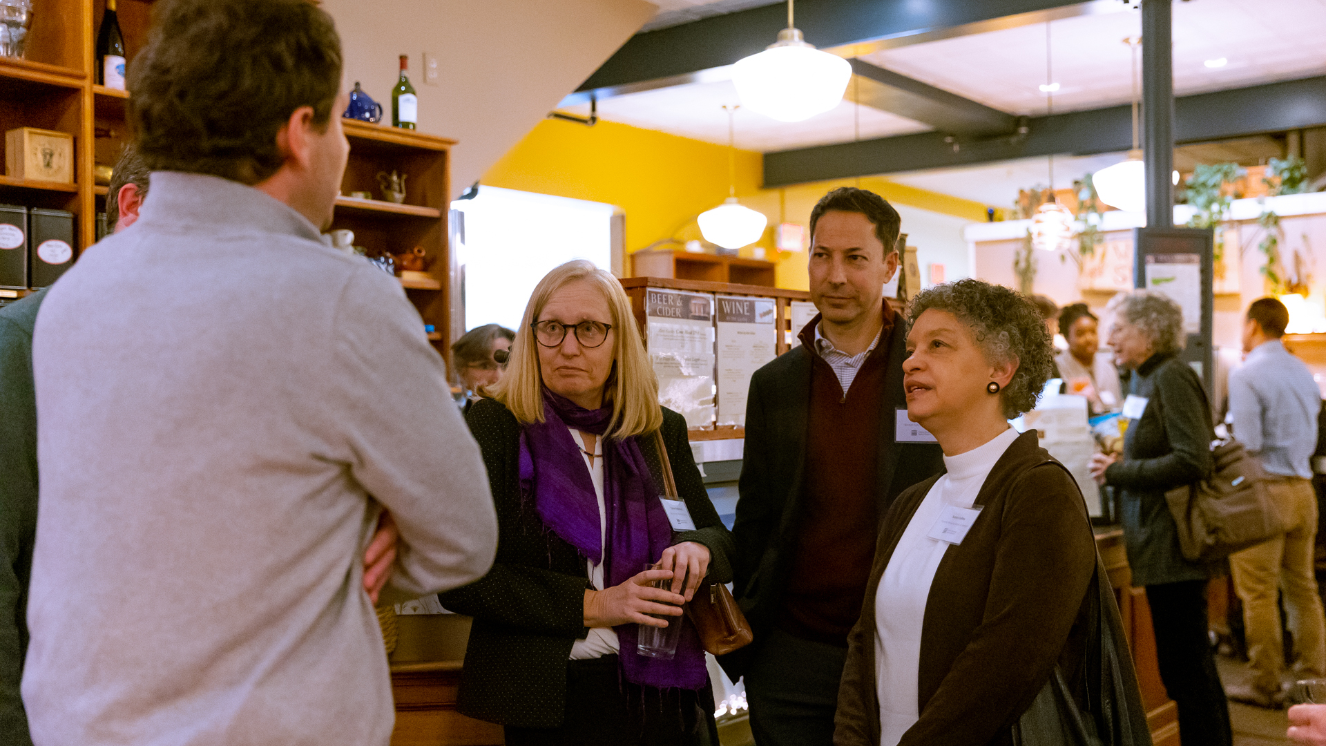 Photo of Susan Collins, Tamar Kotelchuck and Stephen Michon listening to community leaders at The North Branch Cafe in Vermont.