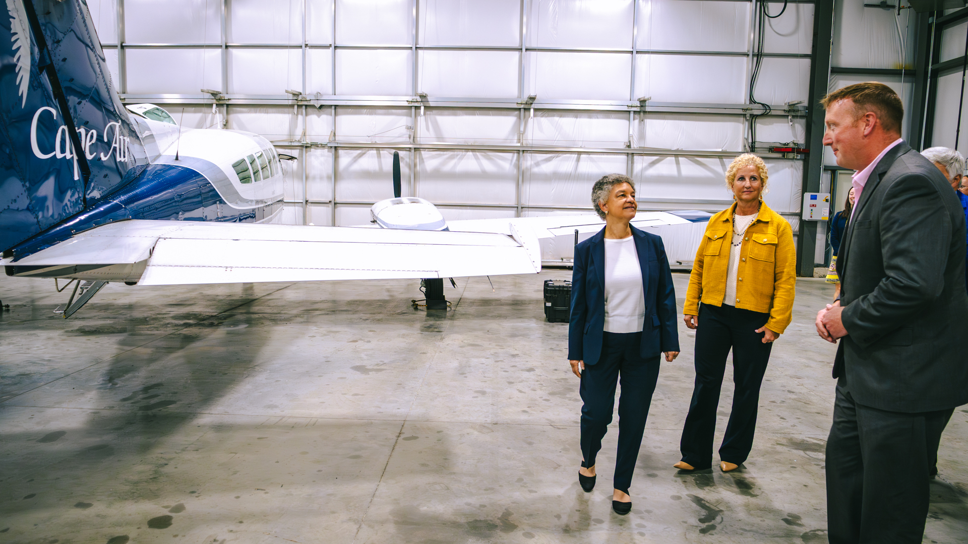 Photo of Susan and Karen touring the hanger of Cape Air and looking at their planes.