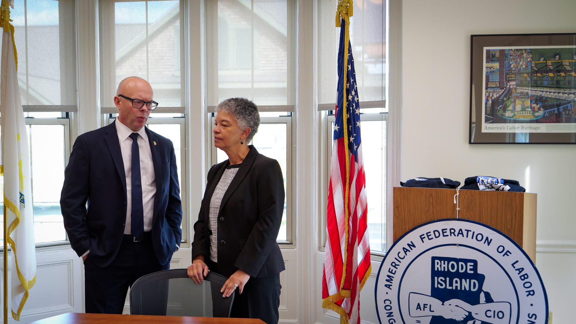 A photograph of Susan M. Collins, President and CEO of the Boston Fed, talking with participant of the Labor Leaders meeting in Providence, Rhode Island.
