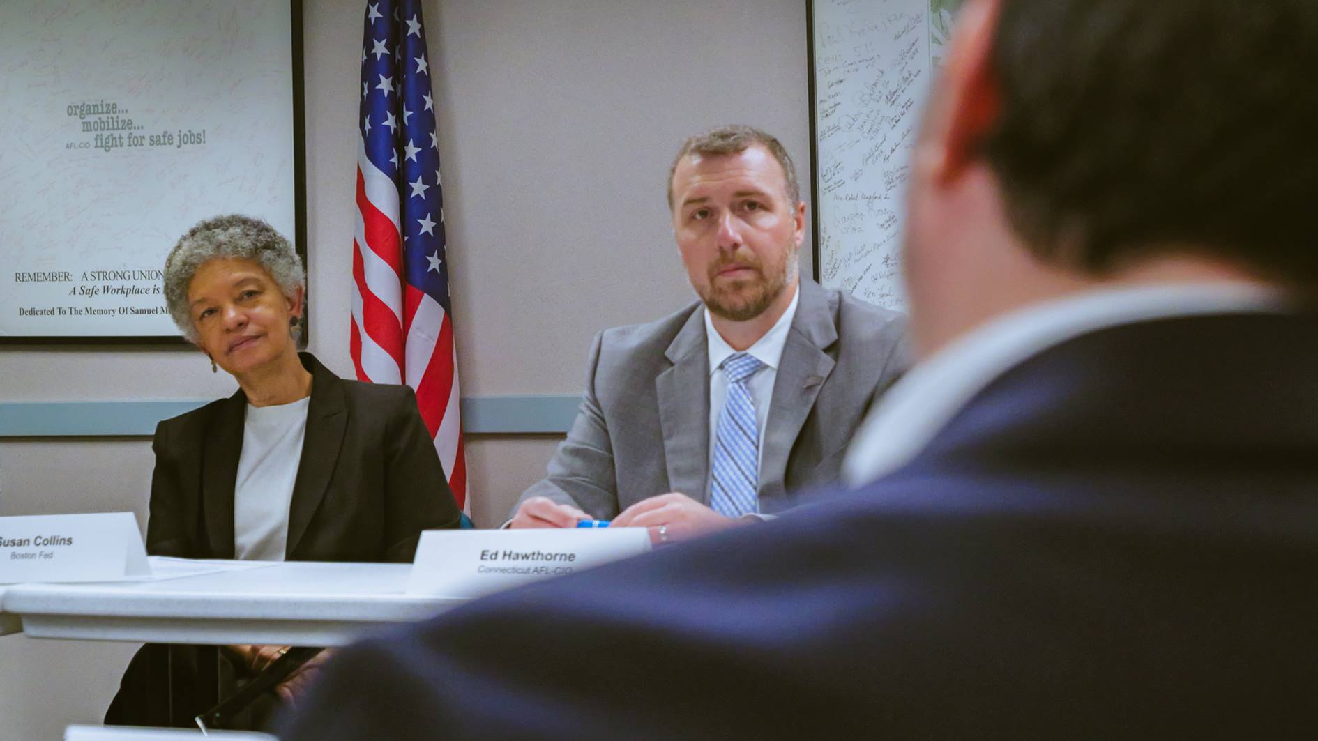 Photo of Susan M. Collins and Ed listening to Stephen Margo during the conversation.